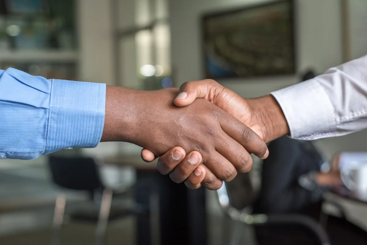 UKG Ready Partner vs Direct: 5 Critical Differences 3 UKG partner vs direct Business partnership handshake representing UKG Ready partner vs direct implementation decision
